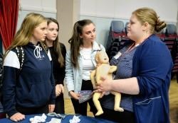 Midwife Emily Wood speaks to (left to right), Holly Hamilton, Kelsie Grey and Lauren Wason.