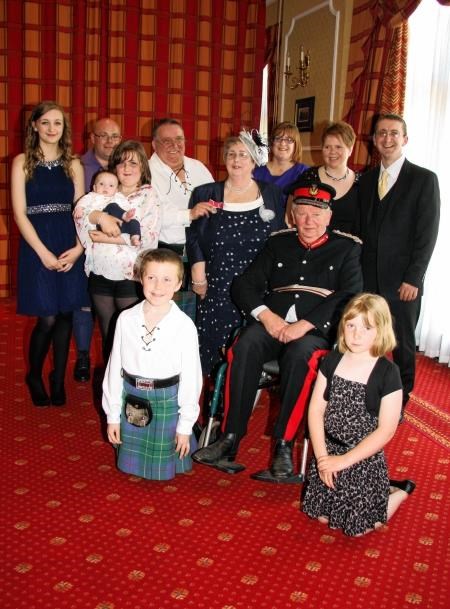 Pat (centre) with husband Willie (left in white), family and friends