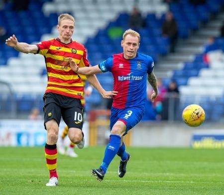 Caley Thistle captain Carl Tremarco puts in a challenge to win the ball.
