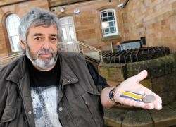 Pete Carson with the medal found in the well