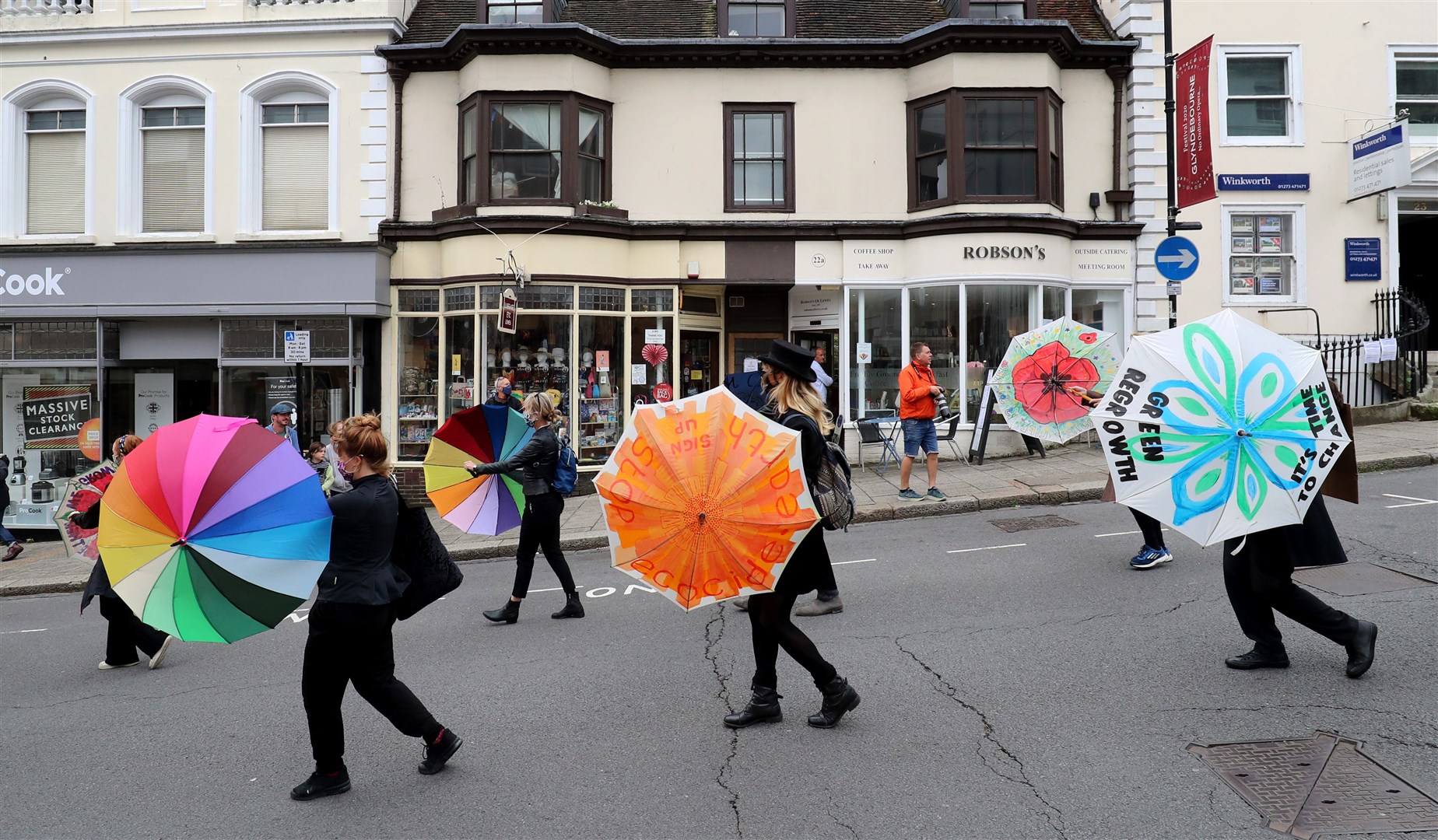 The city’s Procession for the Planet featured black-clad mourners and a jazz band “to mark the death and destruction wrought by humans on our natural world” (Gareth Fuller/PA)