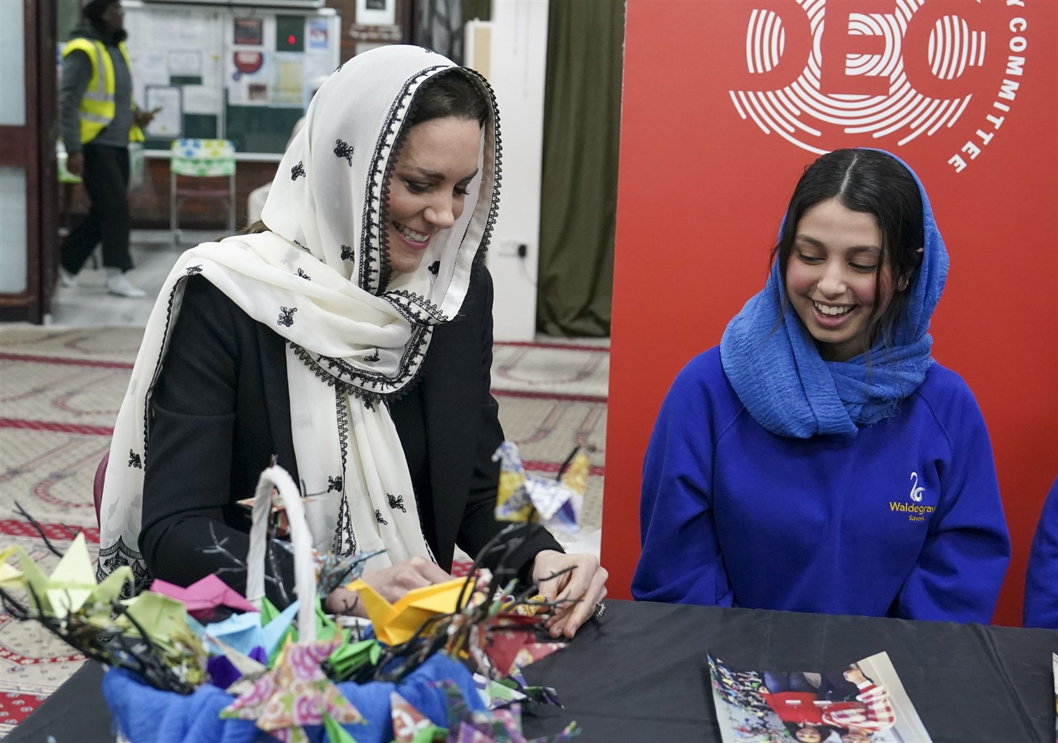 The Princess of Wales makes an origami crane with Dila Kaya at the Hayes Muslim Centre (Arthur Edwards/The Sun/PA)