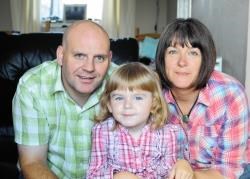 Little Maisie-Cate with her parents Rob and Tracey.