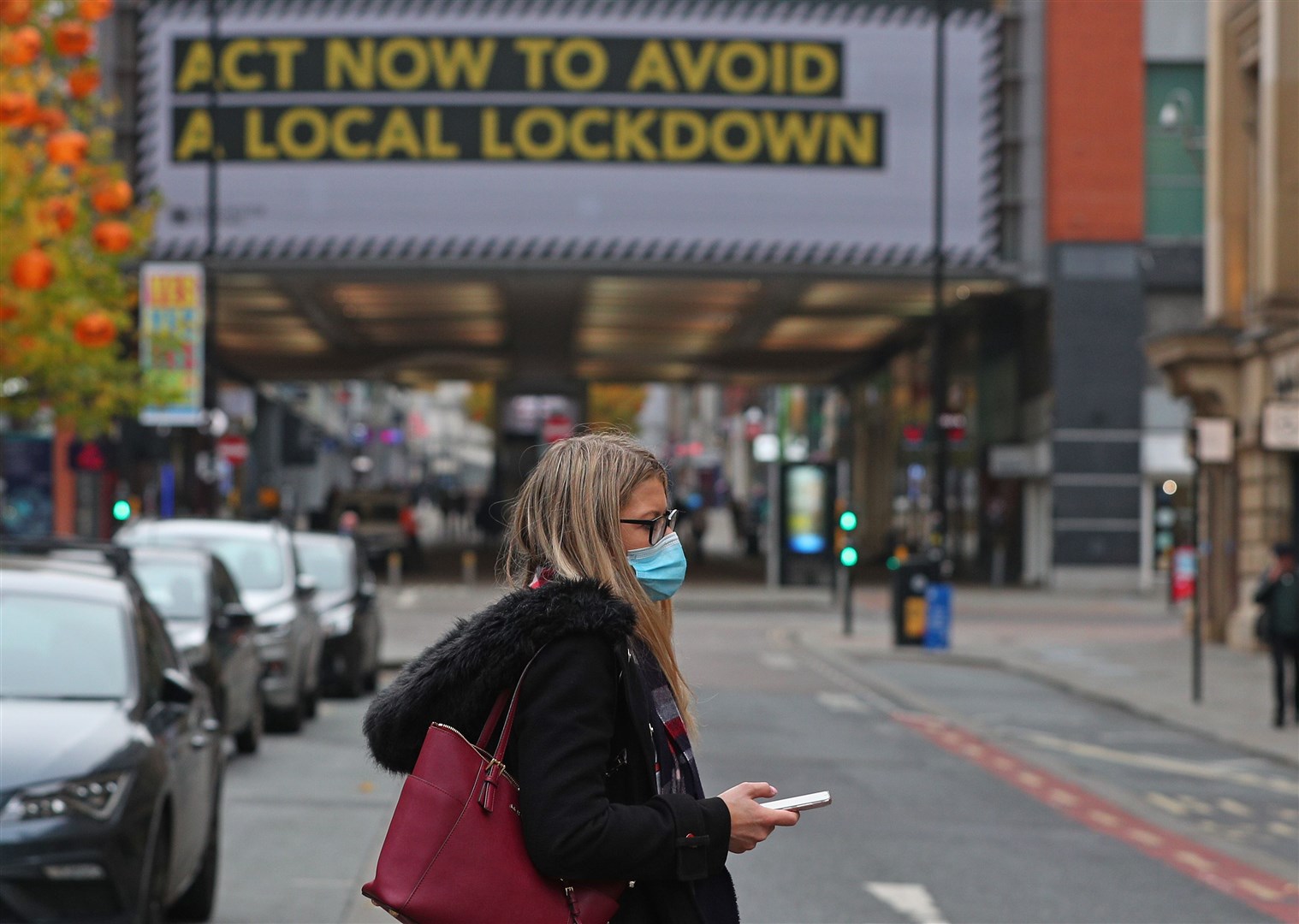 A woman wearing a face covering in Manchester city centre (Peter Byrne/PA)