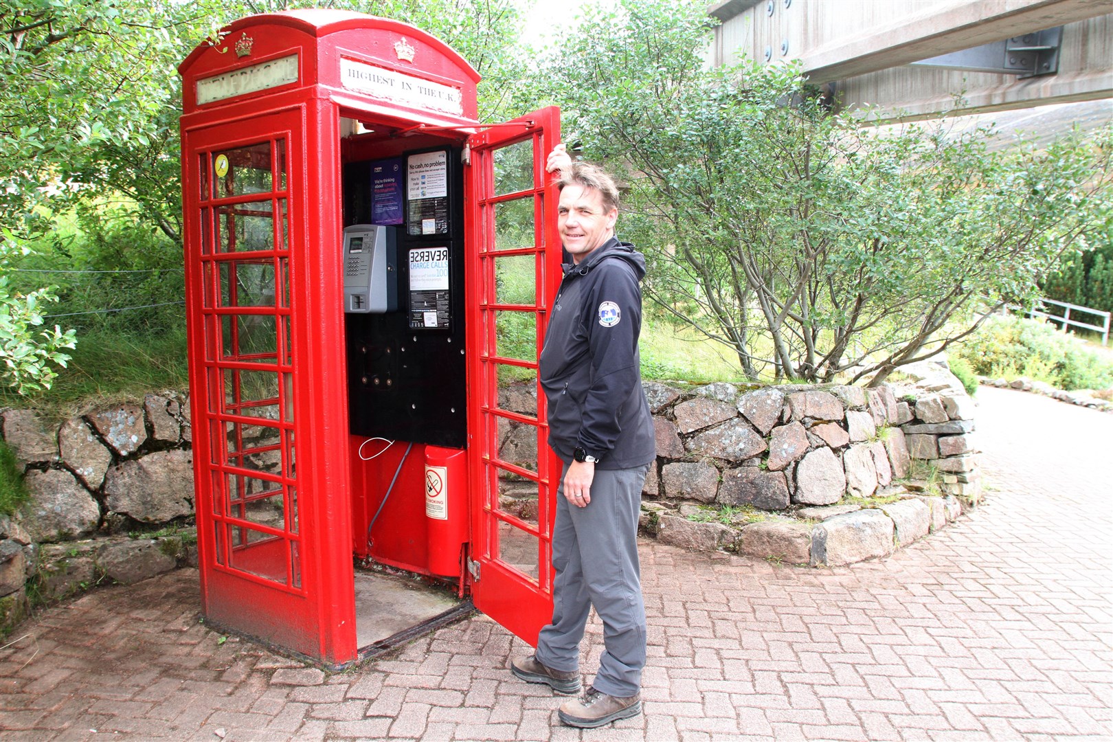 Cairngorm ranger Ruari Macdonald with the popular red phone box at Cairngorm Mountain.