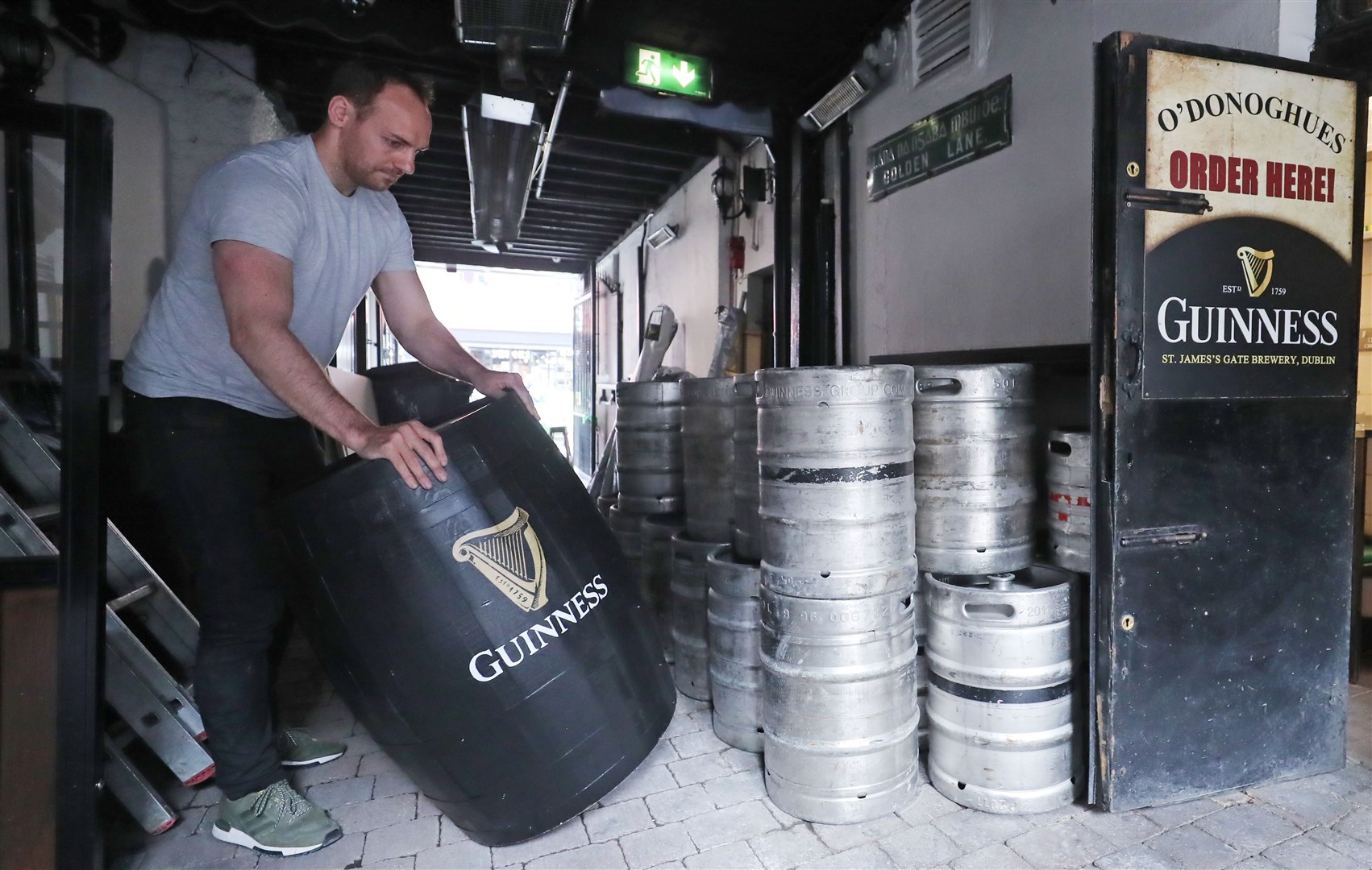 Kevin Barden sets up an outdoor drinking area at O’Donoghues Bar in Dublin (Niall Carson/PA)