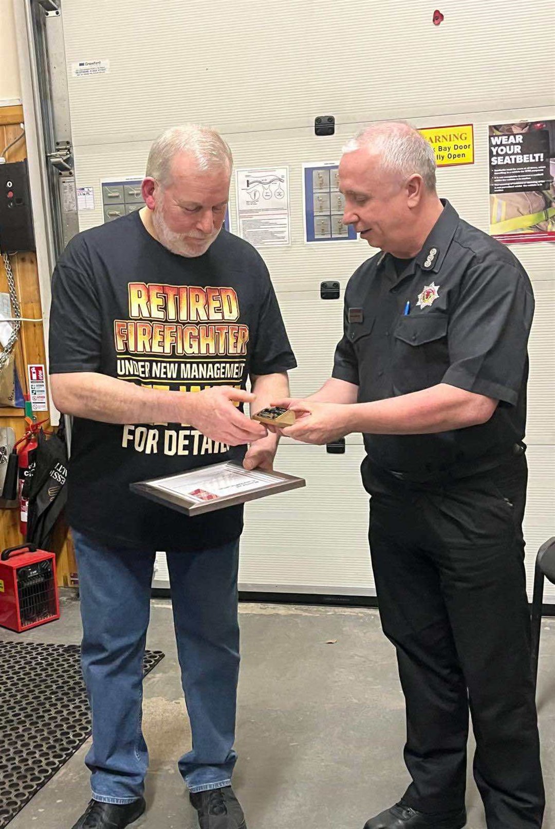 Retiring station commander Dougie Maconald (left) receives his farewell presentation from area commander Nick Nethercott