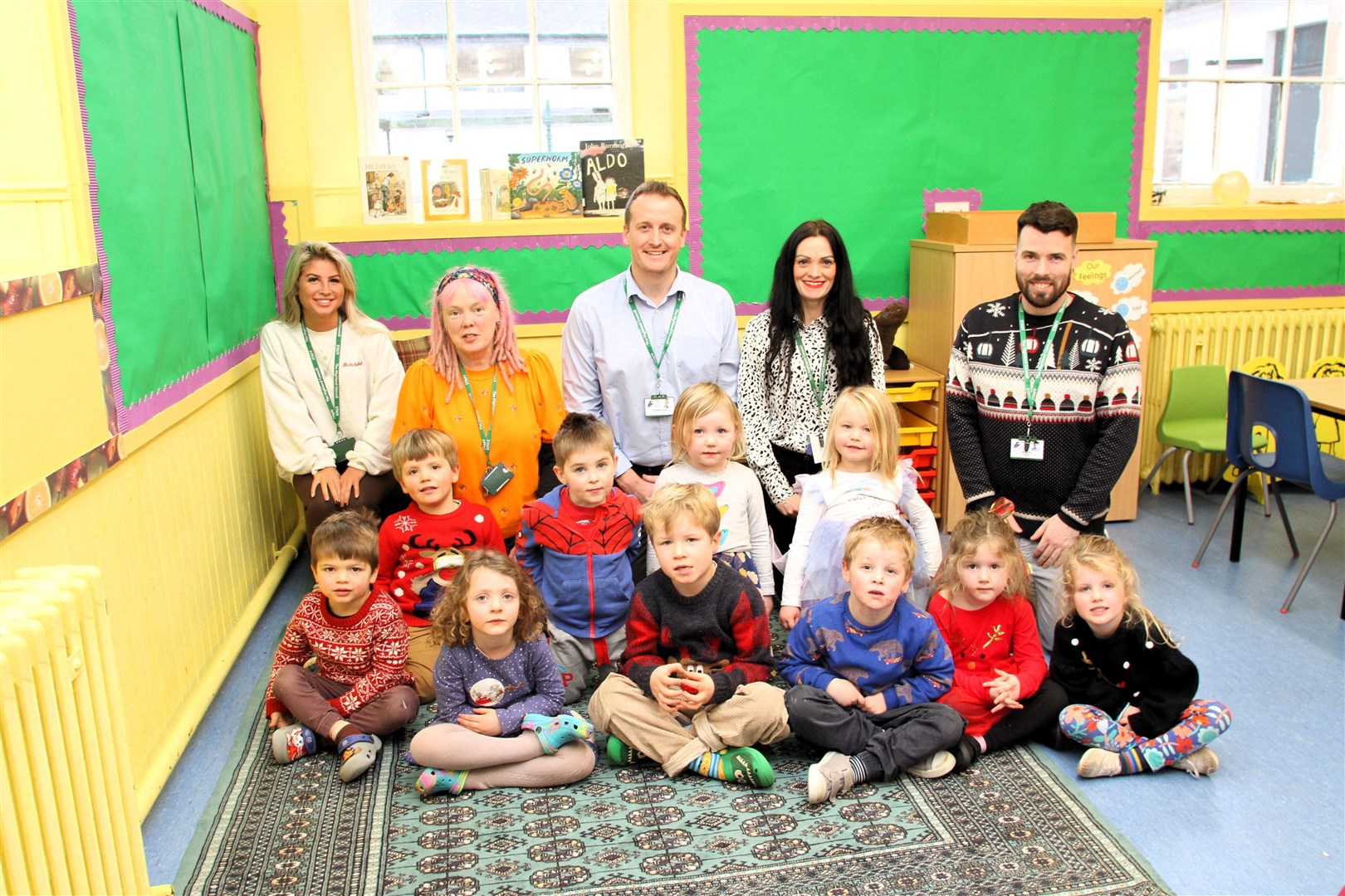 TEAM WORKS: Nursery pupils with early years practitioners Leah Miller and Lorna Wisely, headteacher Chris Scrase, principal teacher Adele Law and support worker Ricky Cox.