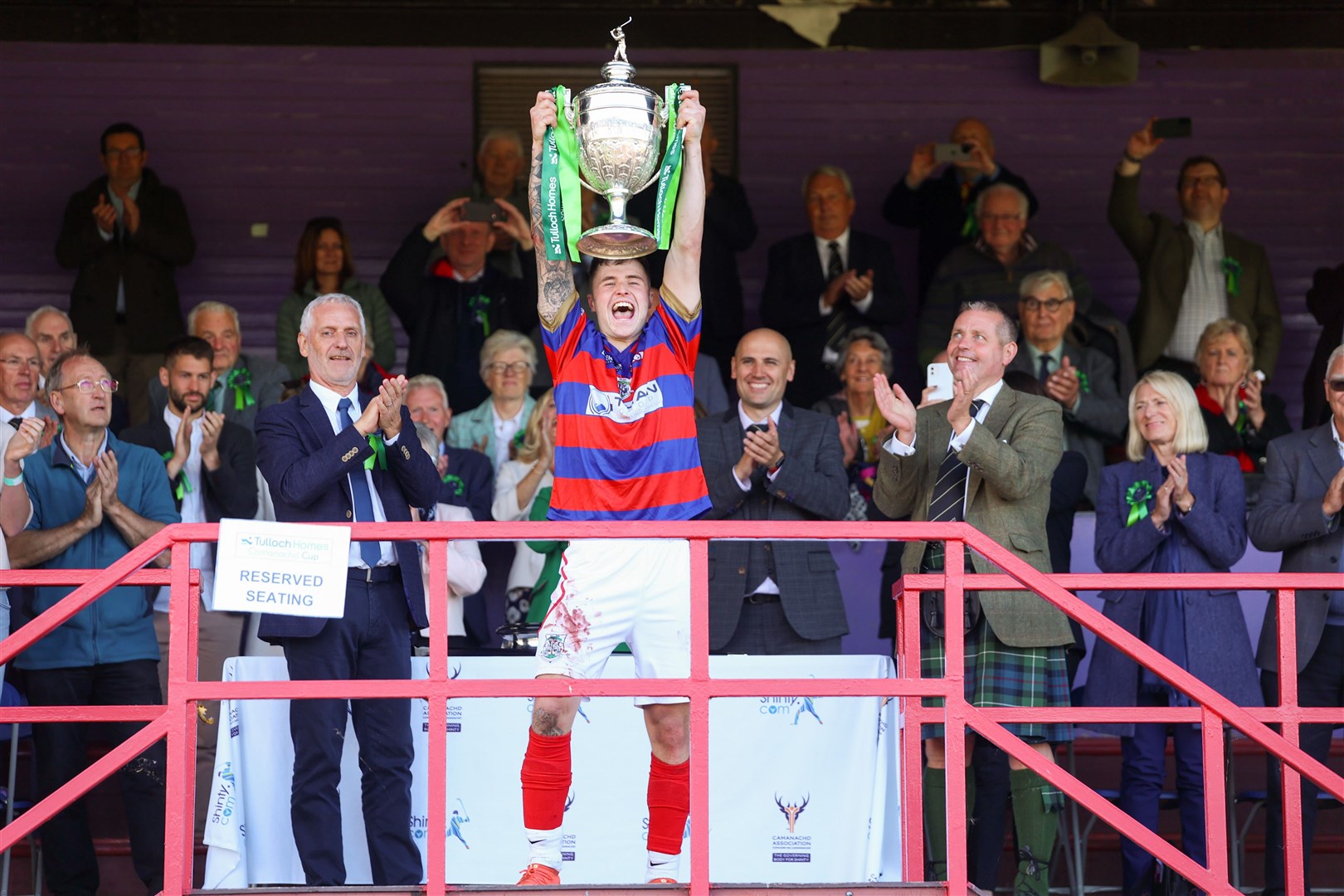 An ecstatic James Falconer lifts the Camanachd Cup at Bught Park after Kingussie's very late win. Picture: Aidan Woods.