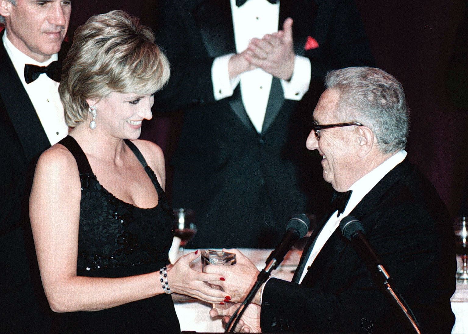 The late Diana, Princess of Wales receiving a humanitarian award from Mr Kissinger in December 1995 (PA)