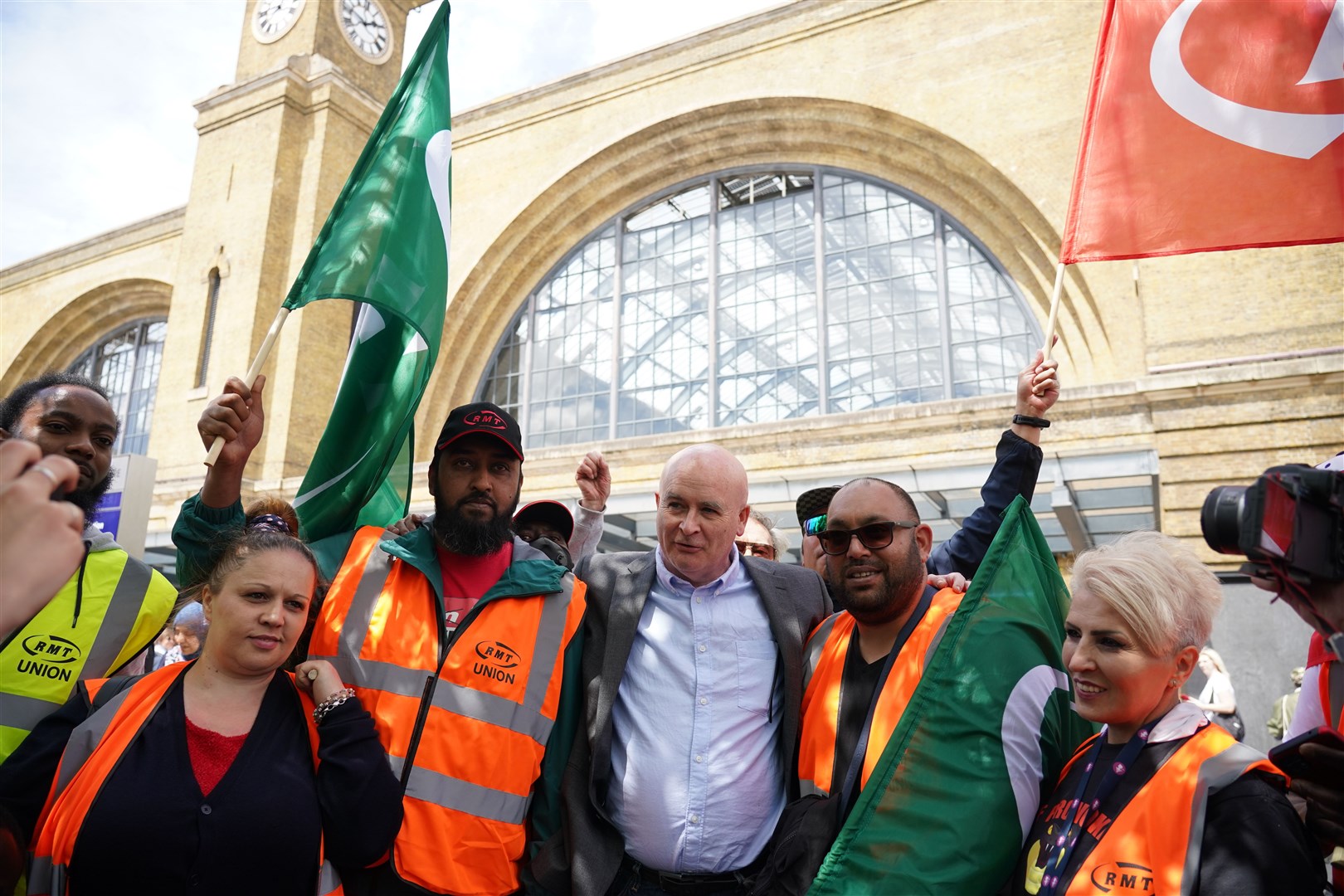 RMT general secretary Mick Lynch, centre, joined a rally outside King’s Cross Station in central London during previous strike action last month (PA)