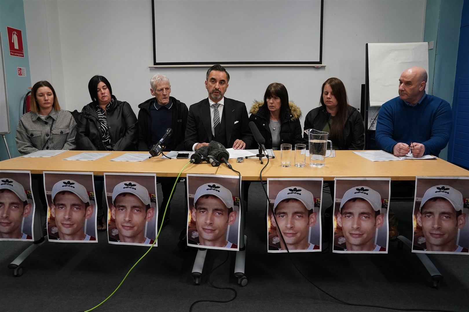 The family of Joseph Sneddon, left to right, sisters Gillian Sinclair and Kerry Sneddon, father James Sneddon, family solicitor Aamer Anwar, mother Jane Sneddon, sister Laura Sneddon, and uncle James Scougall, during a press conference at Edinburgh Central Library (Andrew Milligan/PA)