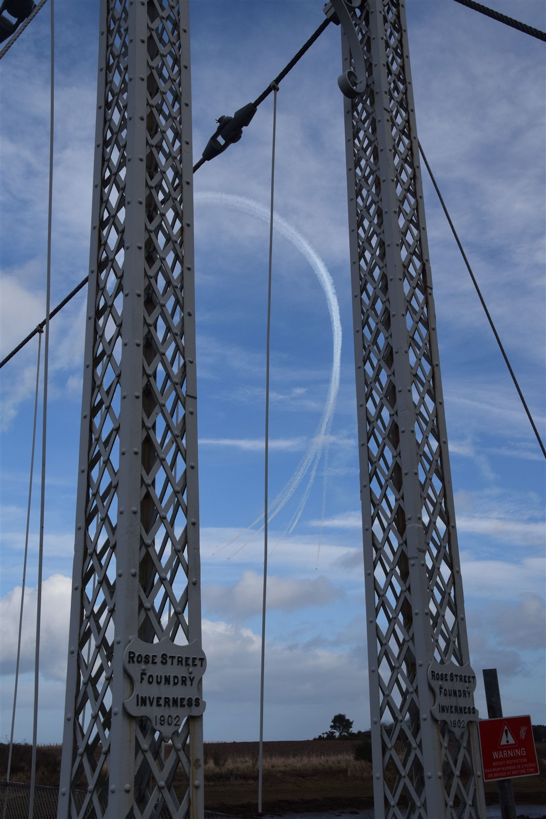The formation team complete a loop with their vapour trail clearly visible beyond the Alexandra Bridge at Tain's Links. Picture: Philip Murray.