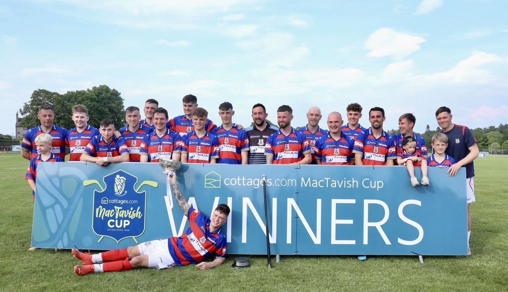 We are the champions! Kingussie celebrate their MacTavish Cup Final win.