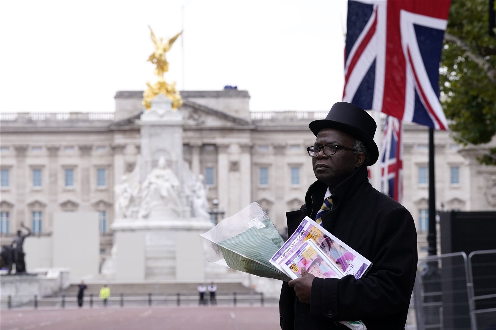 Chris Imafidom carrying tributes outside Buckingham Palace (Danny Lawson/PA)