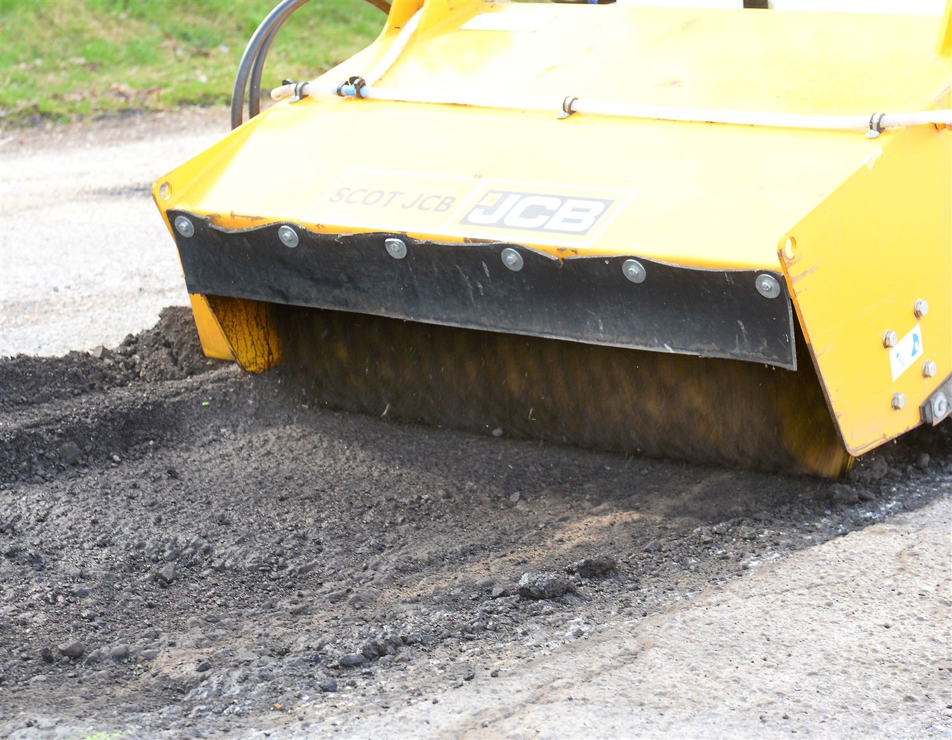 JCB's brand-new PotholePro arrives in the Highlands for Highland Council to see demonstration..Area is then cleaned out..Picture: Gary Anthony..