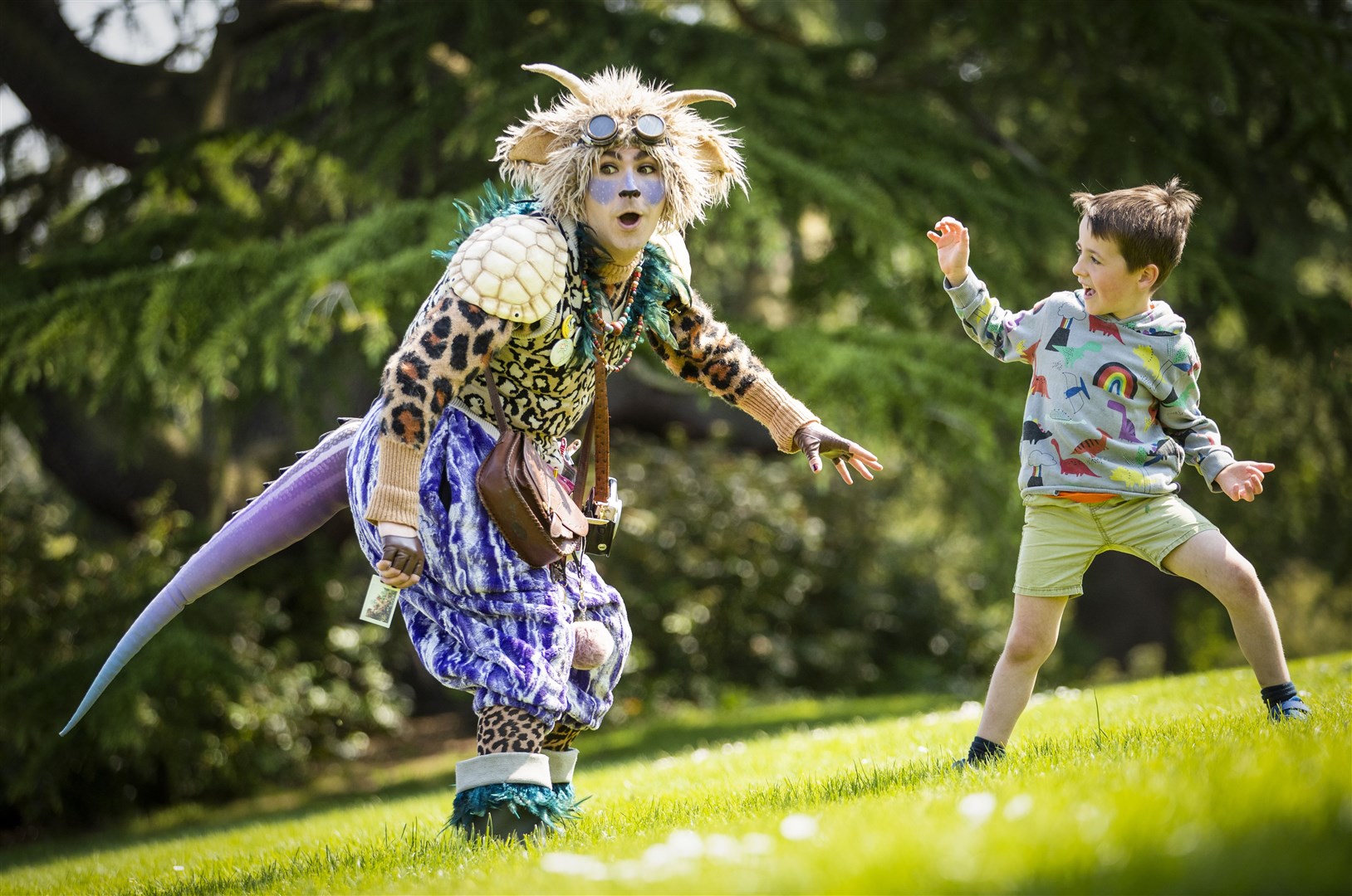 Hamish Lamont, five, meets The Undiscovered Creature during a performance at the Royal Botanic Garden Edinburgh for the Edinburgh International Children’s Festival (Jane Barlow/PA)