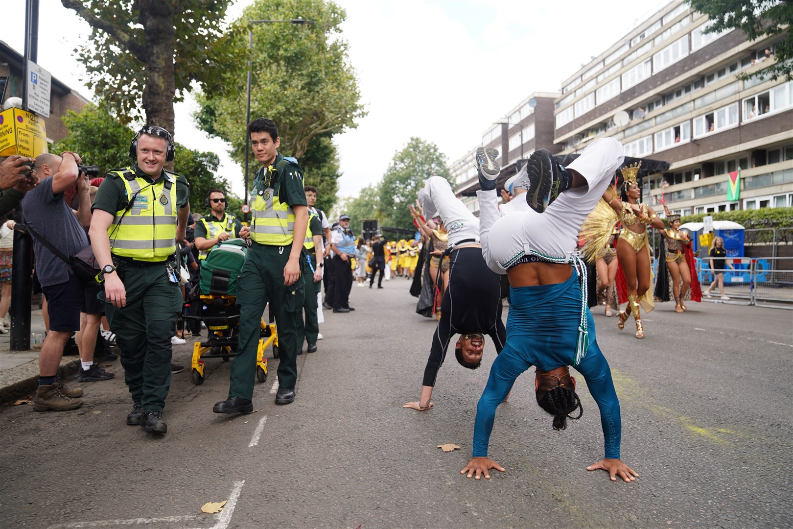 Paramedics pass participants in the Notting Hill Carnival (James Manning/PA)