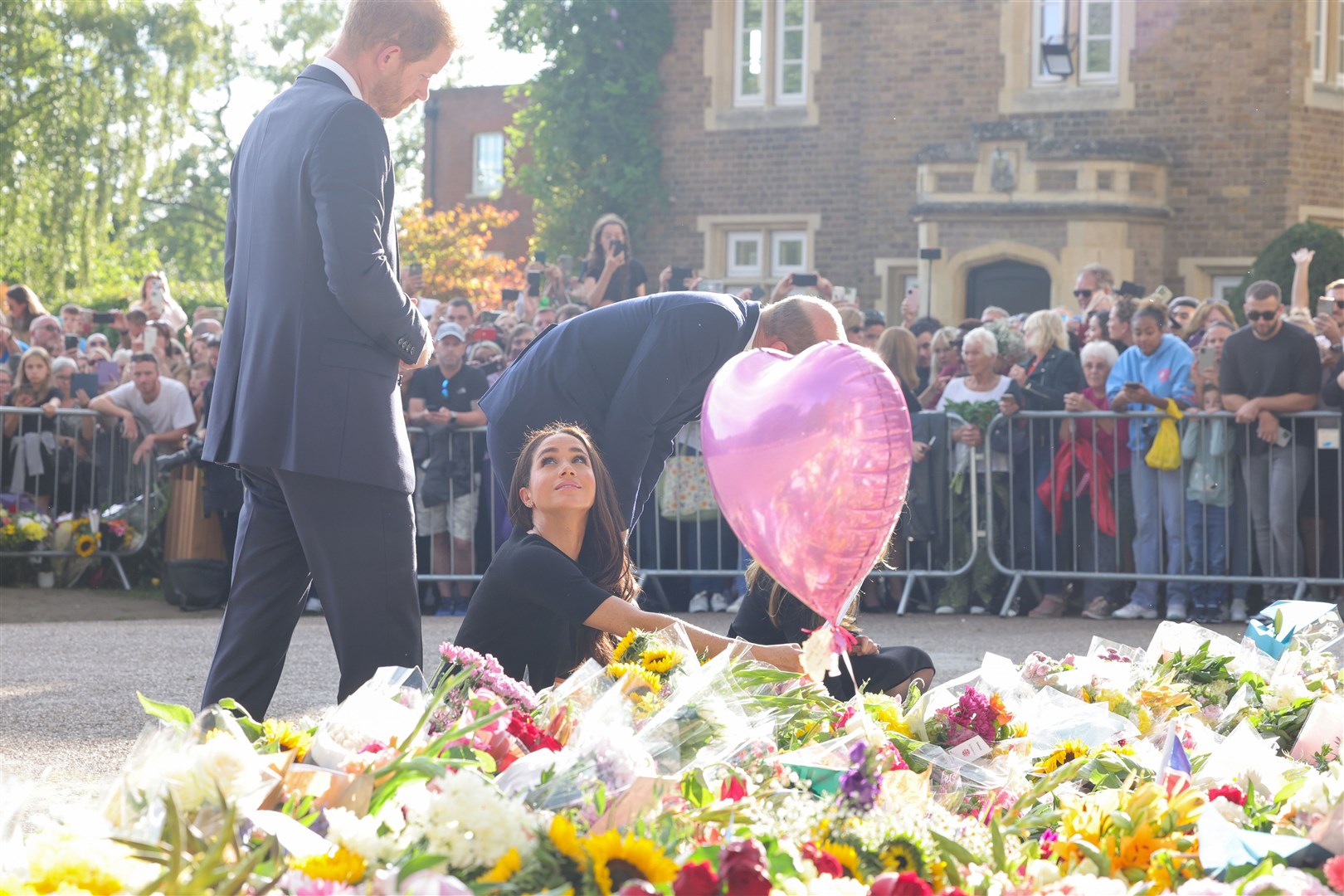 The Prince and Princess of Wales and the Duke and Duchess of Sussex viewing the messages and floral tributes left by members of the public at Windsor Castle in Berkshire (PA)