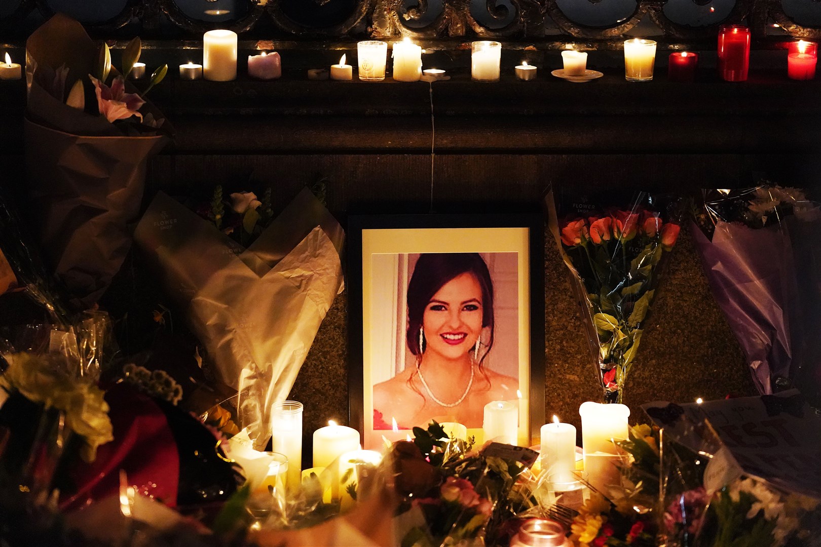 A photograph of Ashling Murphy among flowers and candles during a vigil in her memory in Dublin (Brian Lawless/PA) Wire