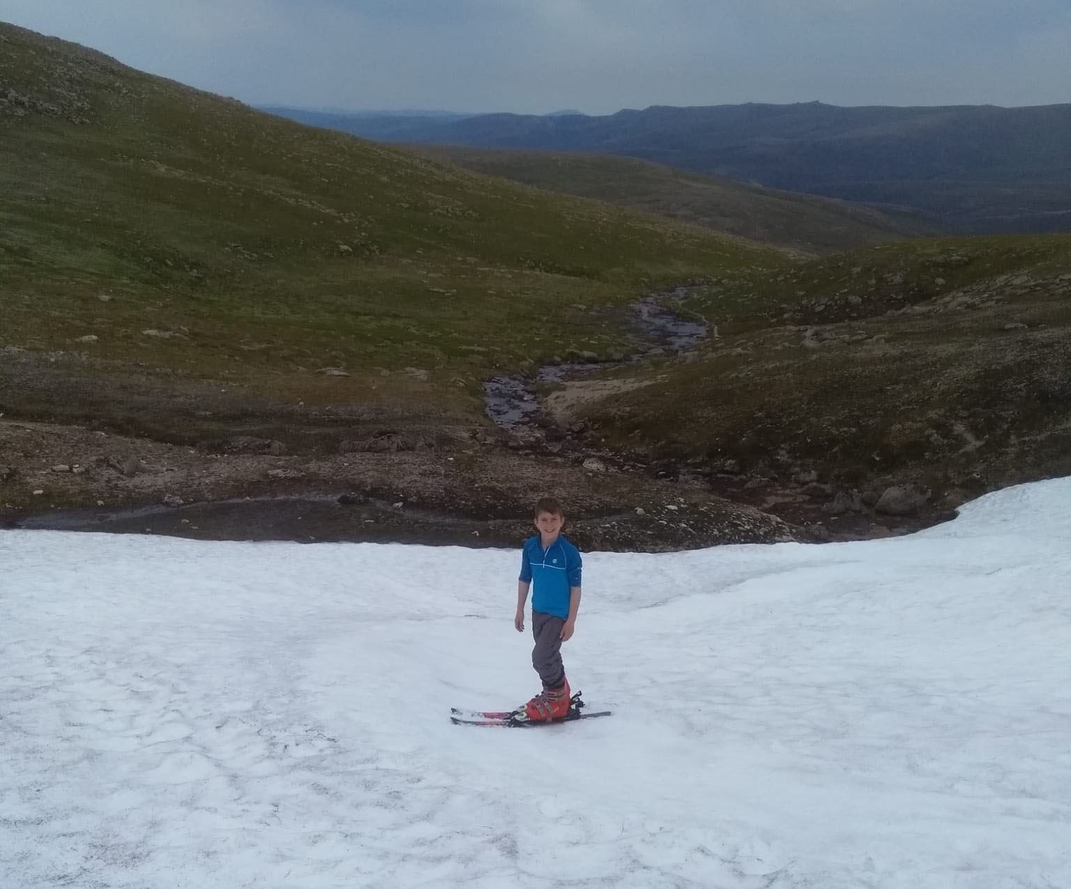 Campbell Hutt (9) on snow patch at Ciste Mhearad in the Cairngorms today as the UK recorded its hottest ever temperature...Pic Colin Hutt/Peter Jolly Northpix