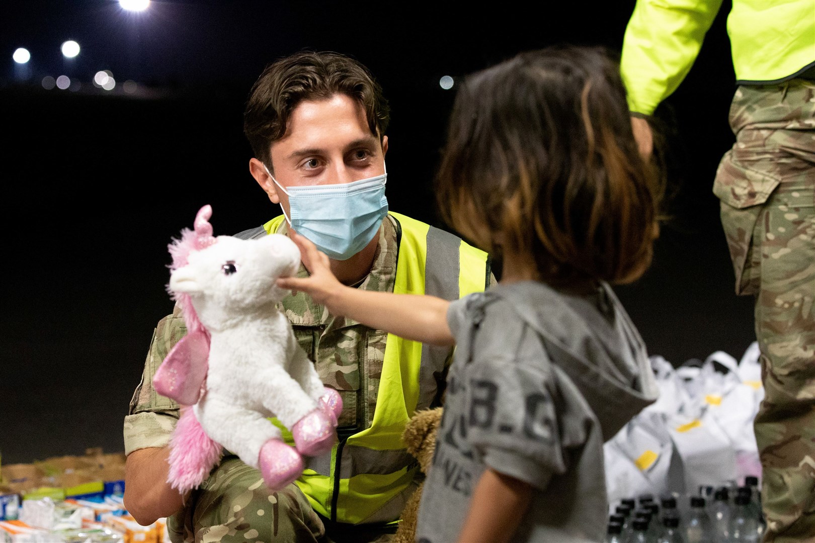 RAF Brize Norton personnel handing out food, drink, toys, and blankets as 'eligible' Afghans were evacuated to the UK. Credit: UK MoD.