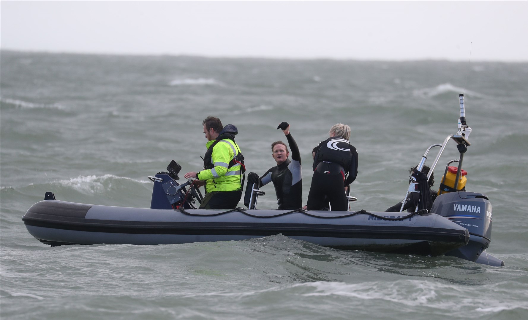 John Bream, centre, waves after his helicopter jump (Andrew Matthews/PA)