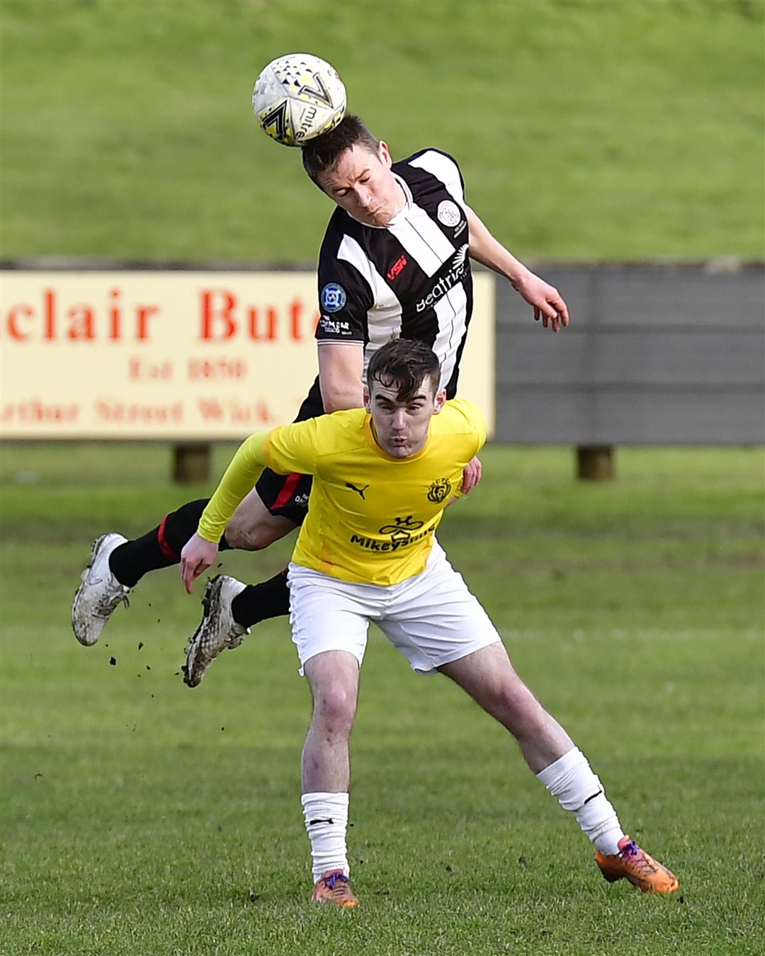 Seamus McConaghy, who has just arrived at Strathspey Thistle on loan, is challenged by Wick's Gary Manson.