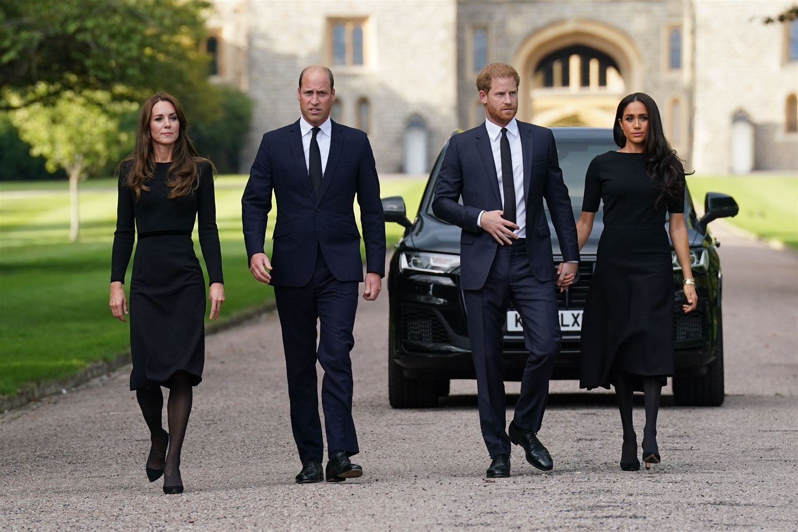 The Princess of Wales, the Prince of Wales and the Duke and Duchess of Sussex walk to meet members of the public at Windsor Castle (Kirsty O’Connor/PA)