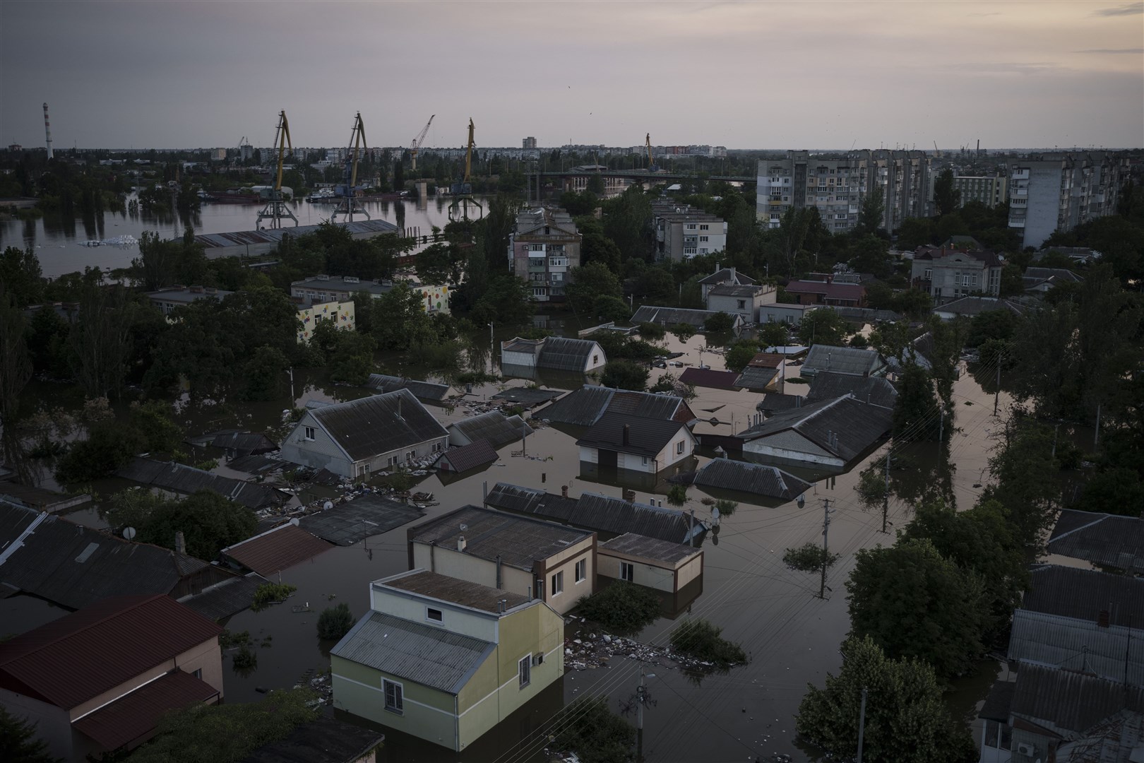 Homes are seen underwater in a flooded neighbourhood in Kherson, Ukraine, after Russia was accused of blowing up a dam (Felipe Dana/AP)