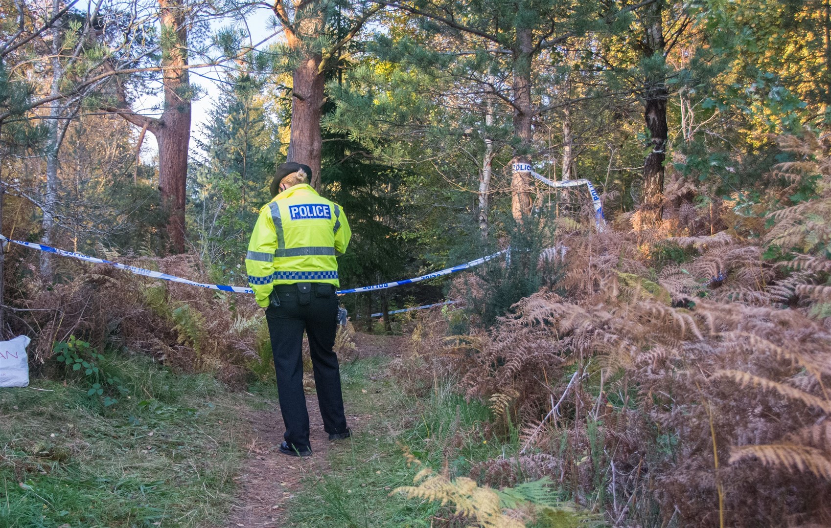 A police officer at the scene of the murder and attempted murders at the woods south of Elgin.