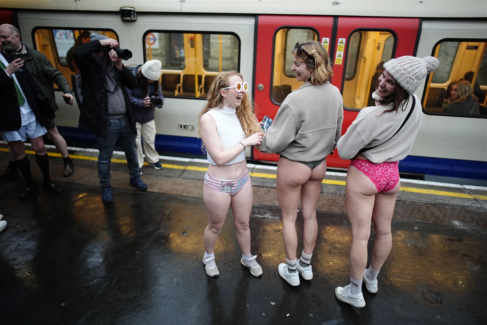 Women display their colourful knickers as part of the annual No Trousers Tube Ride in London (Aaron Chown/PA)