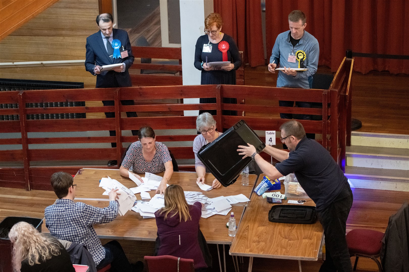 Boxes of votes are tipped out for verification.Moray West, Nairn and Strathspey Election Count at Elgin Town Hall. Picture: Daniel Forsyth.