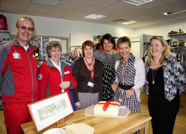 Aggie MacKenzie (second left) with shop staff and charity representatives cut the cake