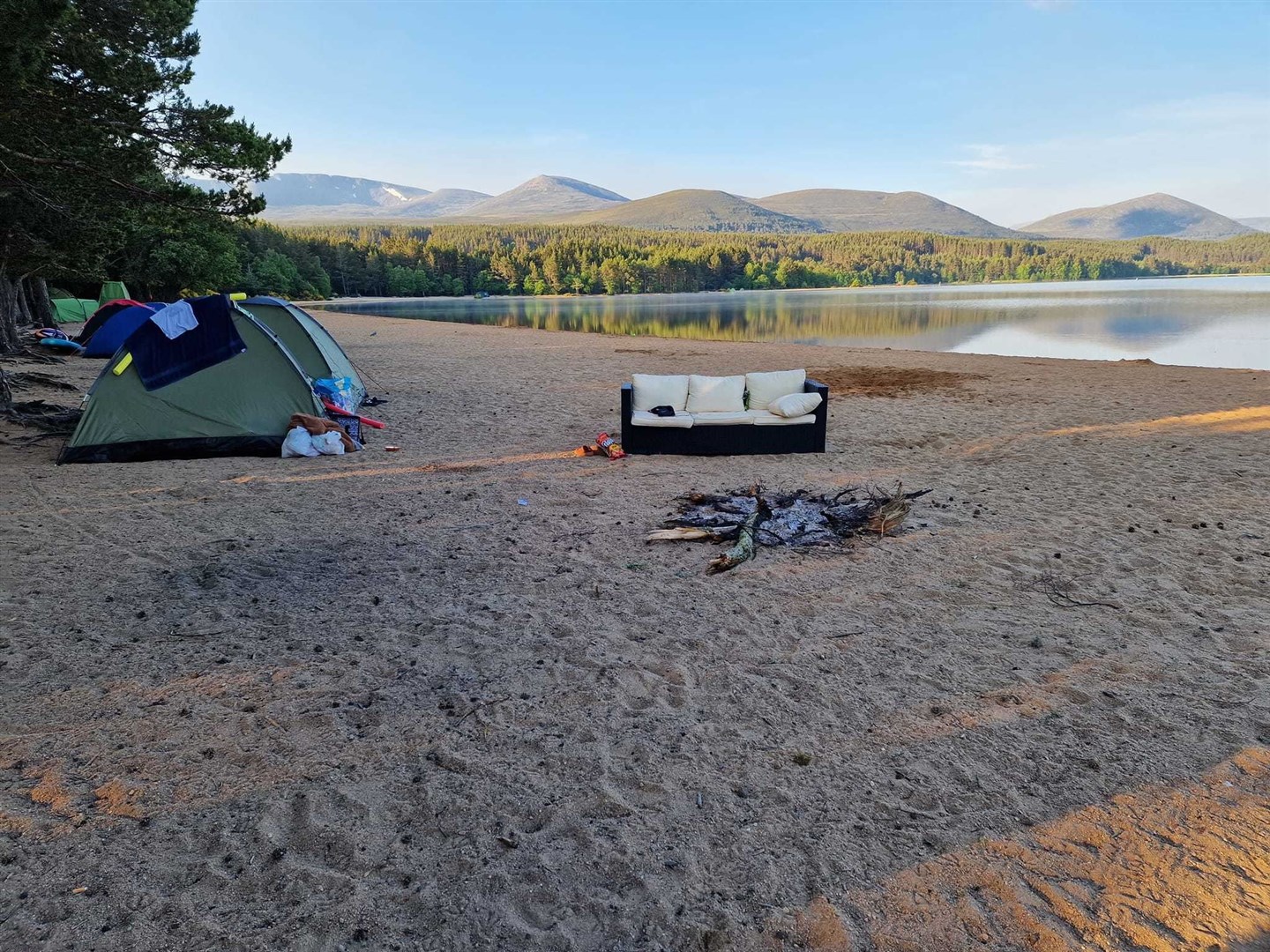 One group of partying campers even brought a sofa onto the beach, as well as lighting a huge fire close by.