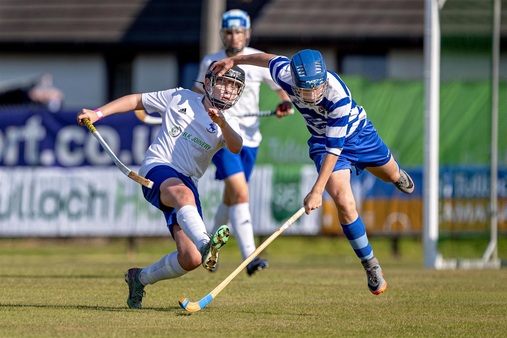 Newtonmore's Donald Ross jumps in ahead of Skye's Andrew Rose in the MacMaster U14 Cup Final at An Aird in Fort William. Pictures: Neil Paterson.