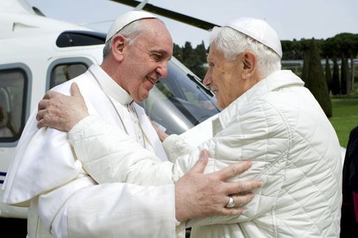 Francis, left, meets pope emeritus Benedict XVI, who served as the leader of the Catholic Church before him, in 2013 (AP)