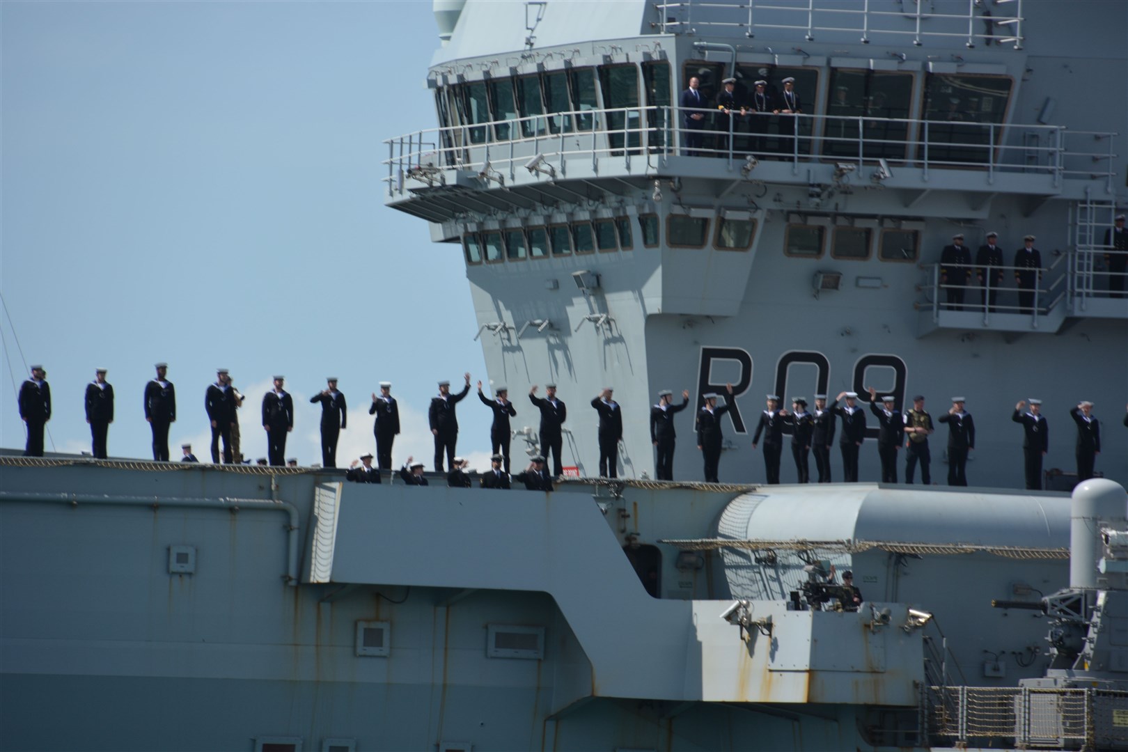 The crew of the HMS Prince of Wales wave as it sets sails from Portsmouth Naval Base (Ben Mitchell/PA)