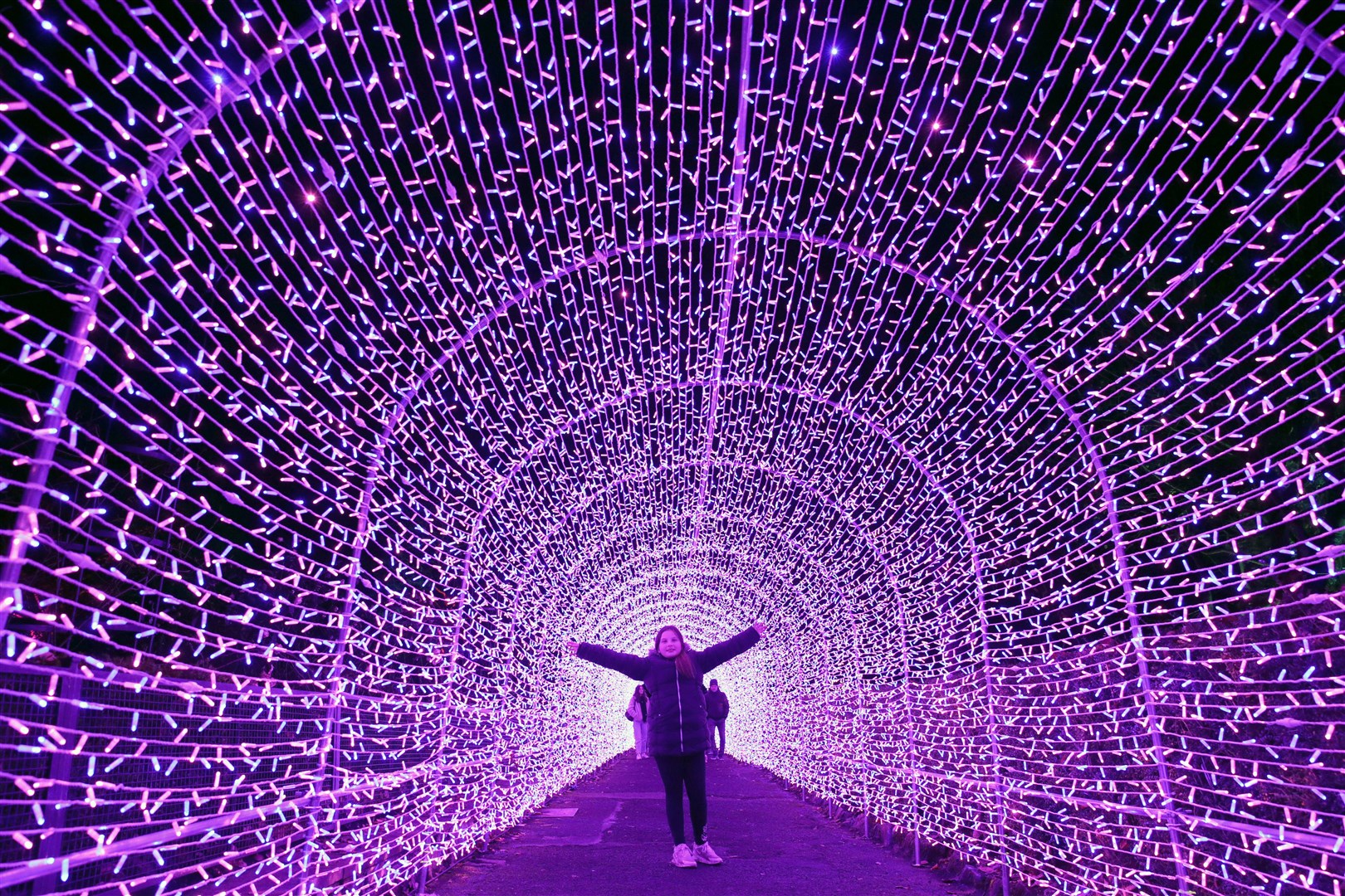 Karis Milligan, nine, in the light tunnel at the launch of Edinburgh Zoo’s Christmas Nights (Andrew Milligan/PA)