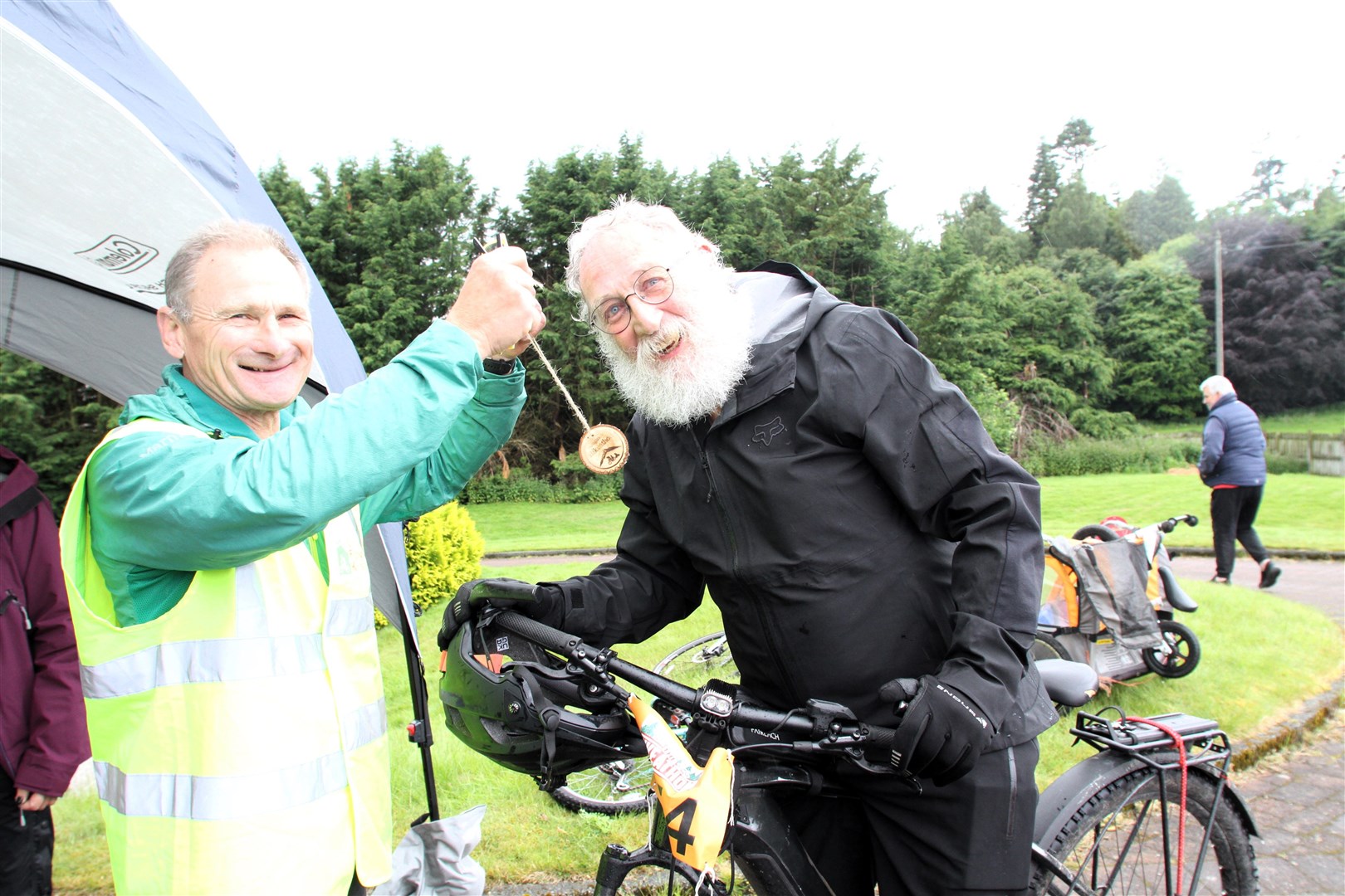 FIRST HOME: First home Mark Thomas receives his medal from Bob Kinnaird