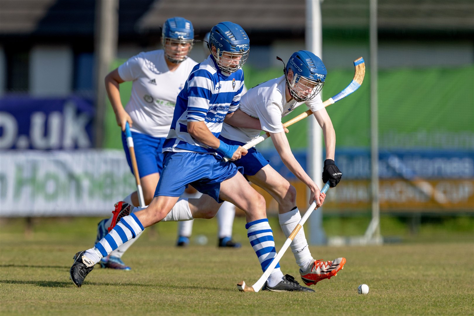 Newtonmore's hat-trick hero James Coyle challenges Finlay Crawford (Skye).