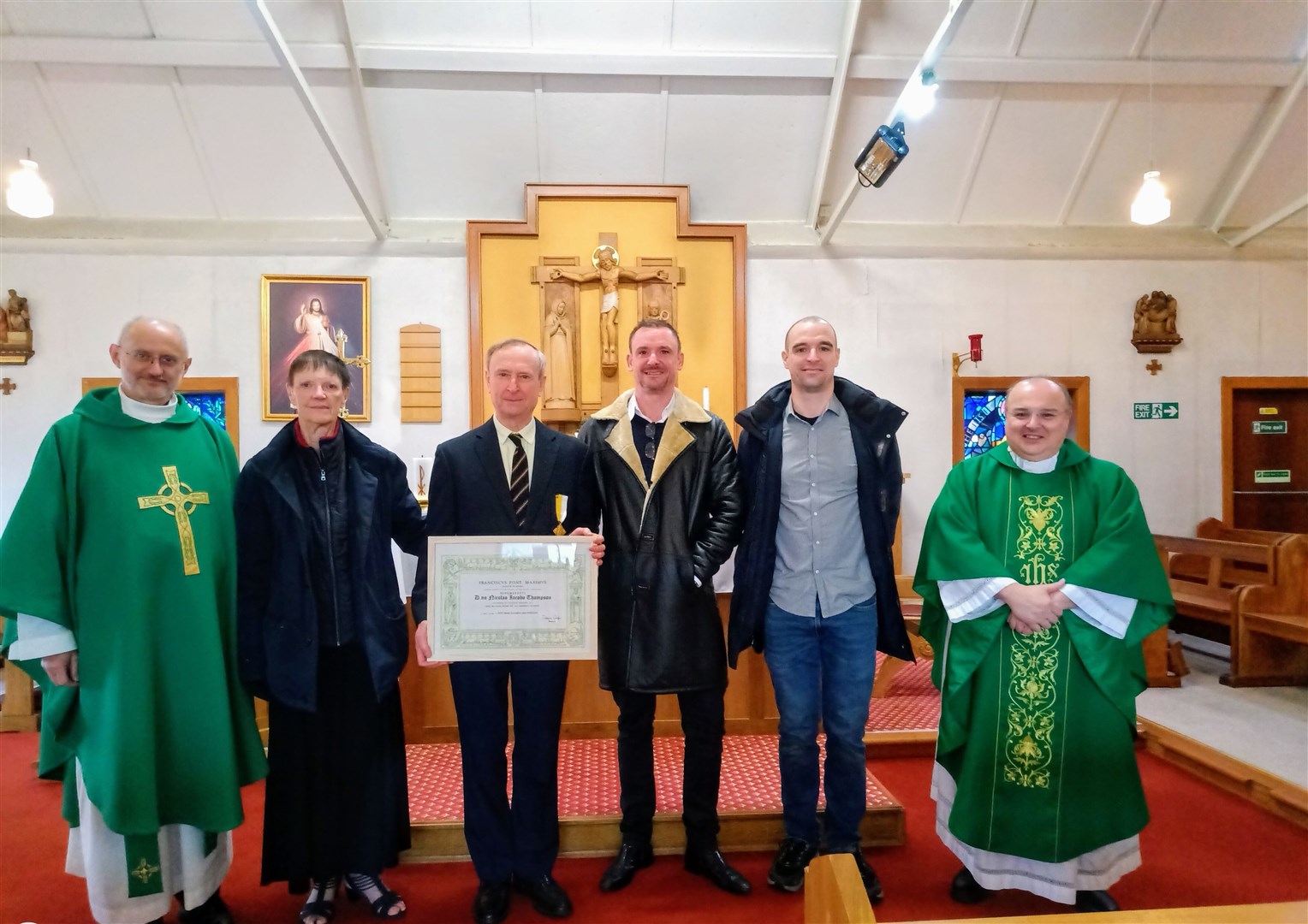 HONOURED: From left, Fr Andrew Harden, the parish priest; Patsy Thompson, Nick Thompson, Andrew Thompson, Christopher Thompson and Fr Domenico Zanre, the Vicar General.