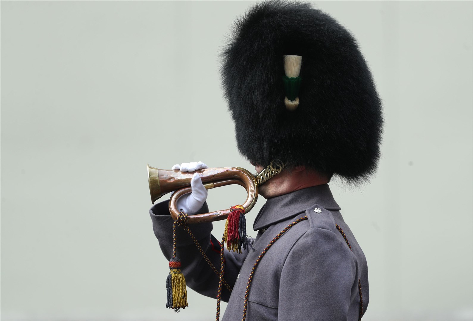 Lance Sergeant Stuart Laing, from the 1st Battalion Welsh Guards, plays the Last Post on a bugle found next to the body of a Welsh Guard who fought during the Battle of the Somme in 1915 (Yui Mok/PA)