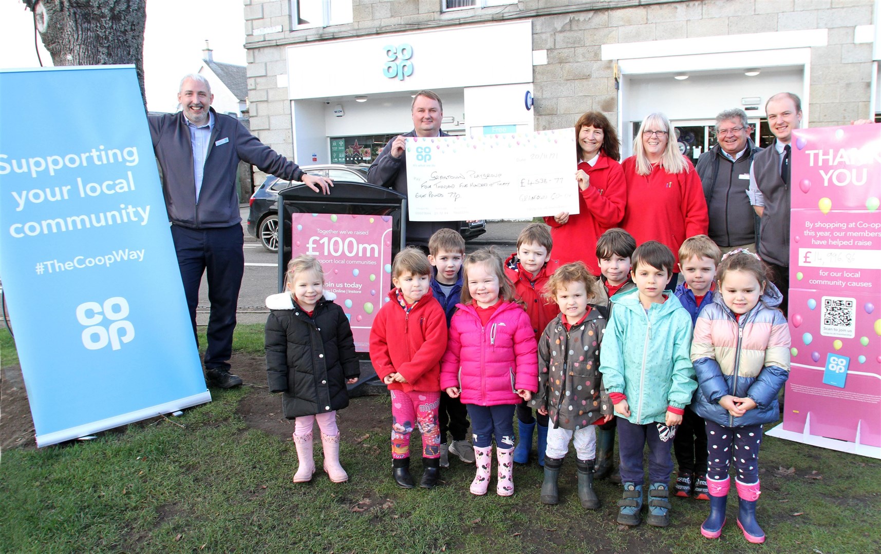 LOTS OF HAPPY FACES: Nicki Watkins, Audrey Fraser and the children from Grantown playgroup accept their cheque from the Co-op team.