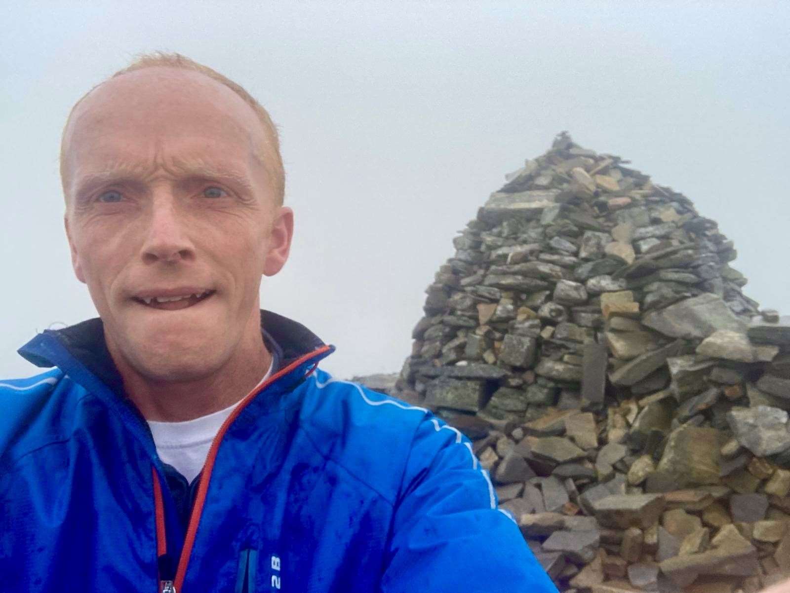 FEELING PEAKY: At the 810m summit, Dr Chris Robinson..