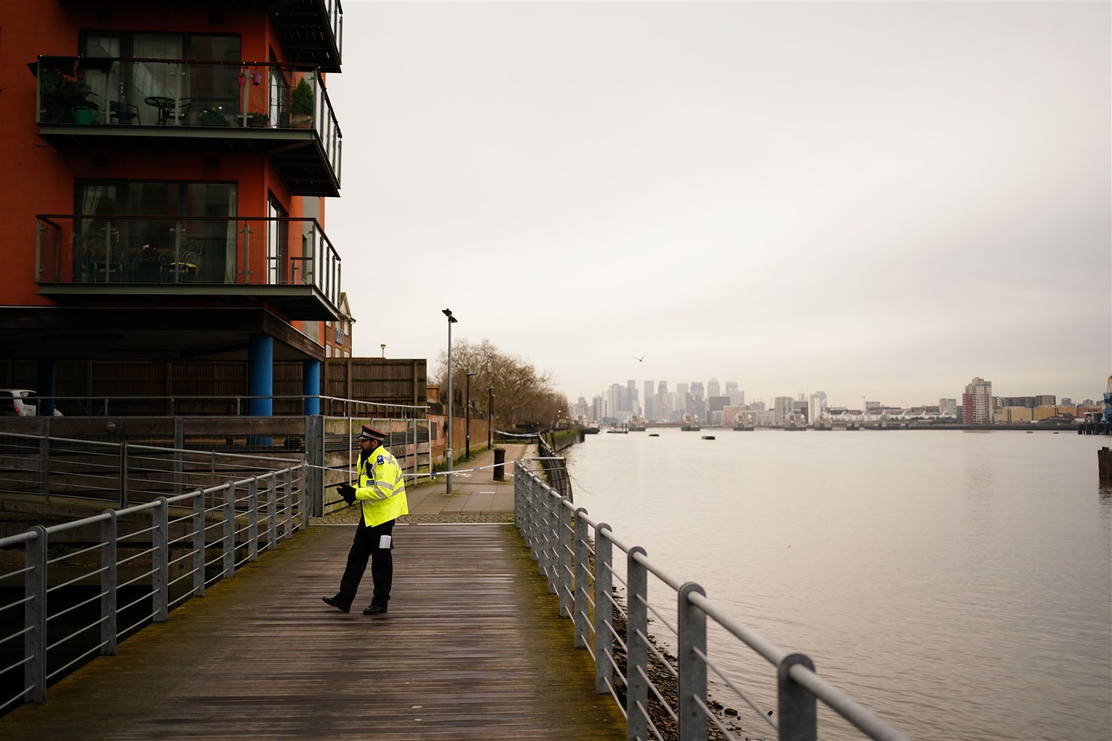 A police officer near the scene beside the Thames (Jordan Pettitt/PA)