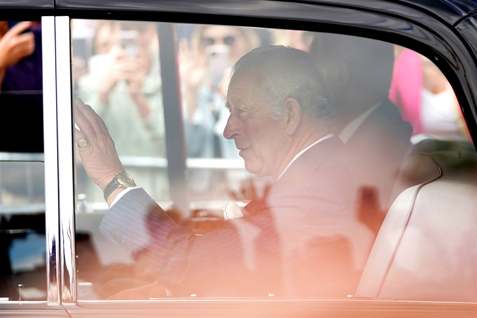 Charles waved from his car as he returned to the palace after the morning’s ceremony (Zac Goodwin/PA)