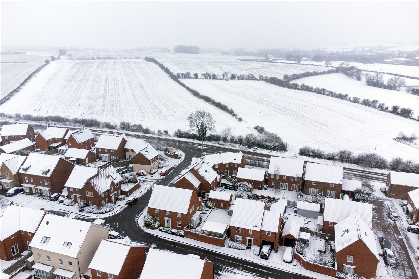 Heavy snow covers houses and fields in Burton Latimer, Northamptonshire (Joe Giddens/PA)