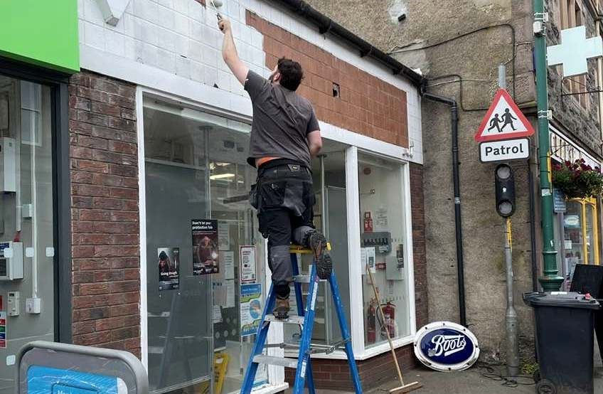 Sign of the times... The ‘Boots’ sign is down on the pavement as the signwriters move in to do its replacement.