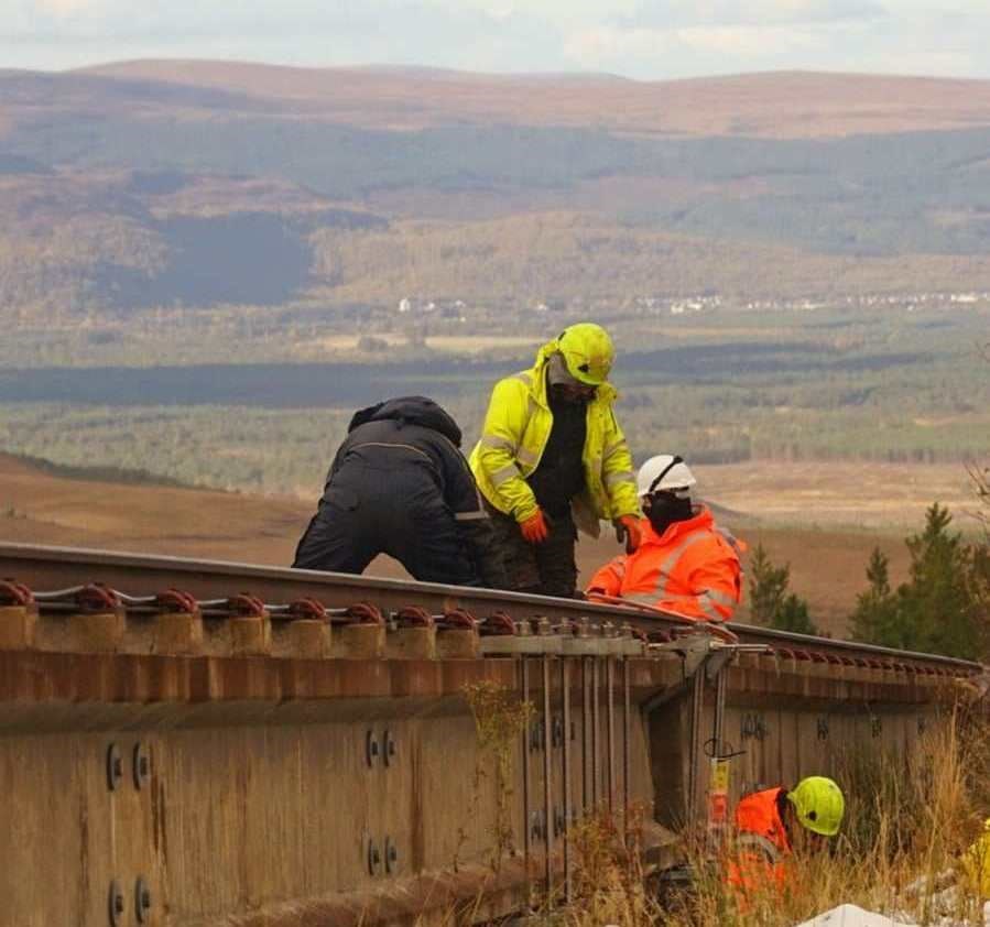 BACK TO WORK: A repair team was photographed by David MacLeod in October - last year.